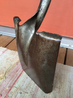 Cut from a piece of sheet metal the failure point is at the bottom of the 'arrow'