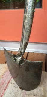 Solid piece of steel.  You can see the 'sweep' for holding soil and the long forged neck that reinforces its connection w/ ash handle