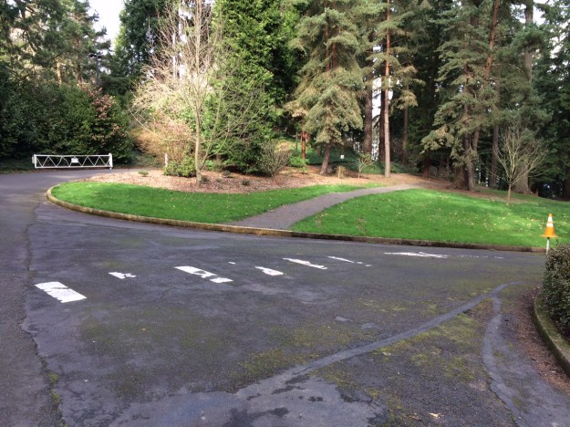 This intersection is at the top of the Canyon Walk, stairs to my right.  Stearns Rd. is topping the hill to the right side of the frame.  The loop road approaches beyond the gate.  The gravel path takes you into the garden (no signs so far)