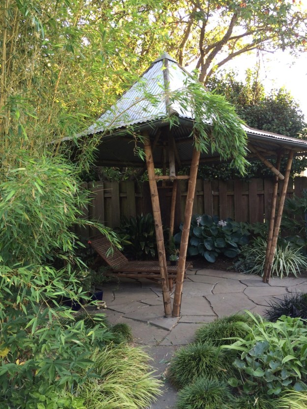 The 'Pagoda', built by Troy Susan of Bambo Craftsman over 15 years ago after a recent roof power-washing, bamboo sanding and re-oiling.  All of our stone work was done by Pete Wilson over a period of several years.  This is a tensile structure and flexes in the wind or if you're standing on the roof...a little disconcerting when you're working on it.
