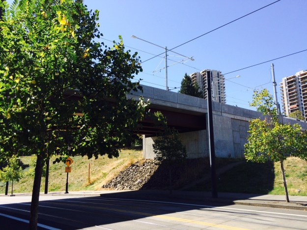 Here the trolley passes under the Orange Line above where it lands at Naito Pkwy. 